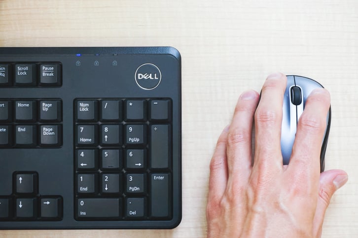 hand on mouse with keyboard