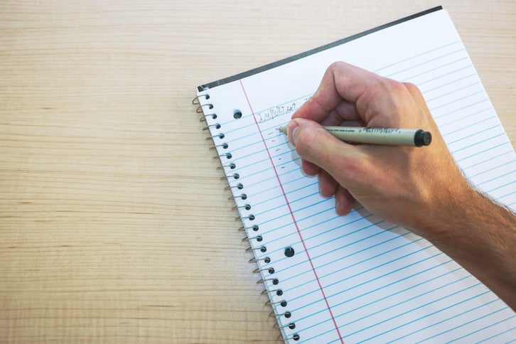 drafting notes on a paper pad