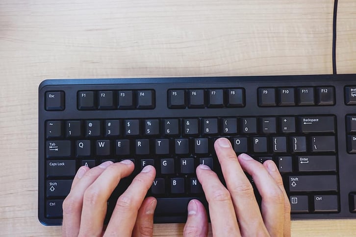 typing on a black keyboard