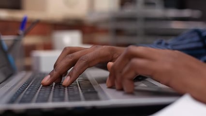 hands typing the first steps in creating business documents on laptop