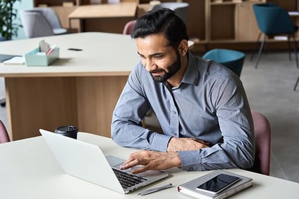 business-man-non-native-English-writing-on-computer