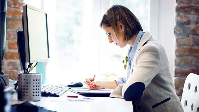 business-woman-technical-writing-at-desk