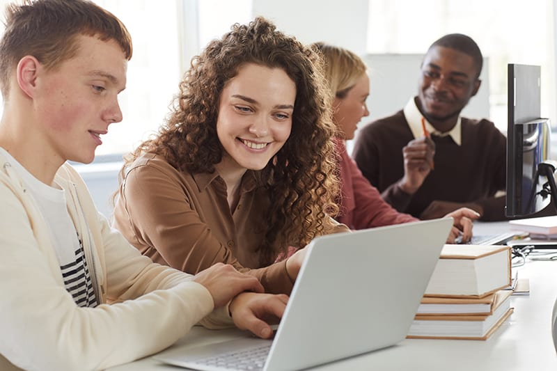 college-students-writing-in-business-office-on-laptops