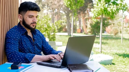 man-beard-writing-technical-document-laptop