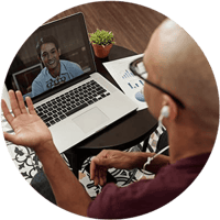 online-writing-executive-coaching-call-on-laptop-with-headphones-circle