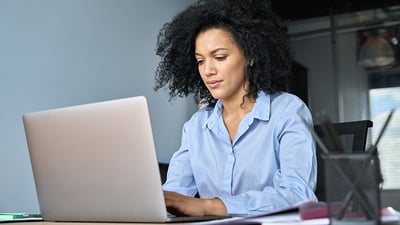 woman-writing-business-letter-on-laptop-focused