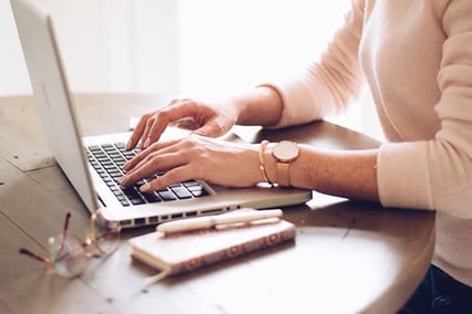 woman-writing-on-a-laptop-computer-sitting-taking-executive-summary-training